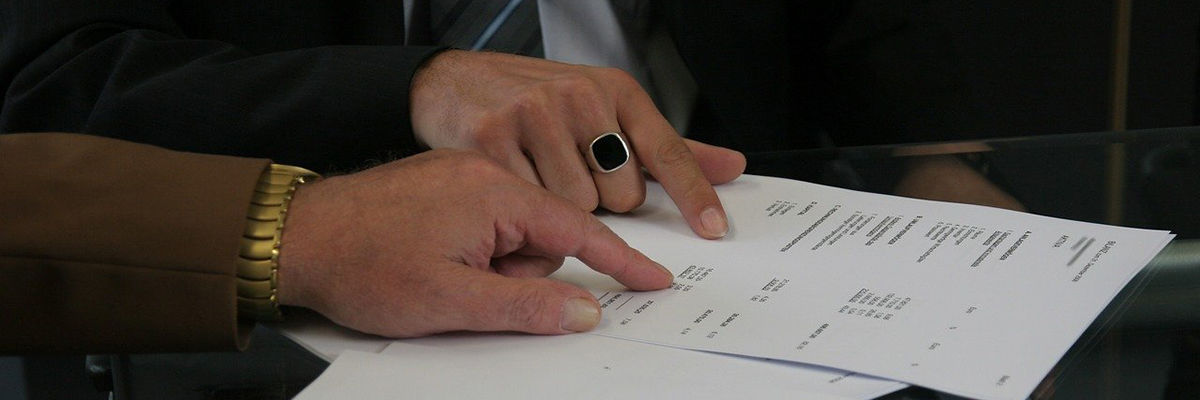 Two hands reviewing paperwork