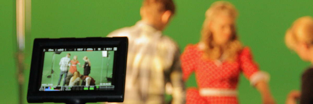 Actors in front of a green screen.