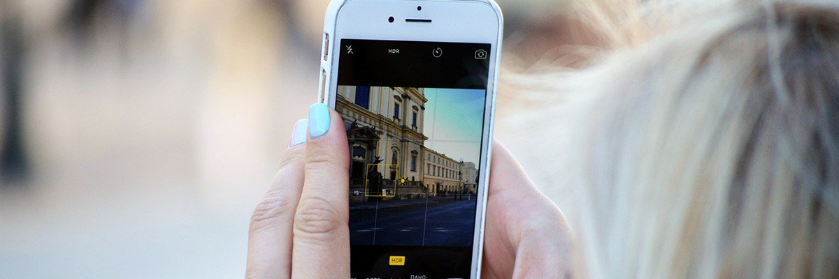 Woman taking instagram photo with her mobile device.