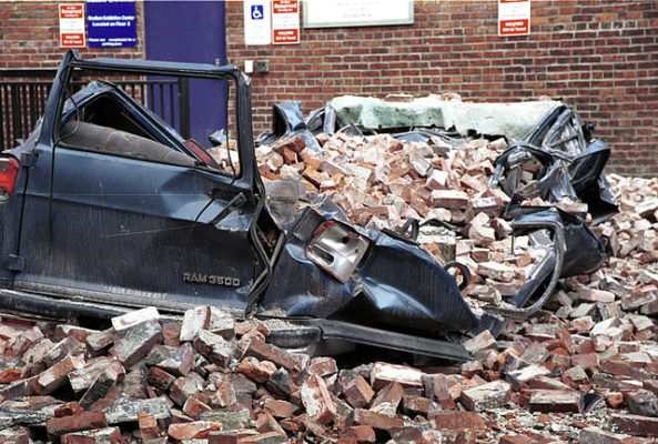 A large vehicle crushed by bricks in a Seattle parking lot.